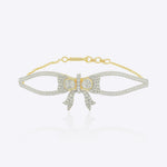 Silk Bow Bracelet in 14kt gold with a refined bow design and interlaced stones