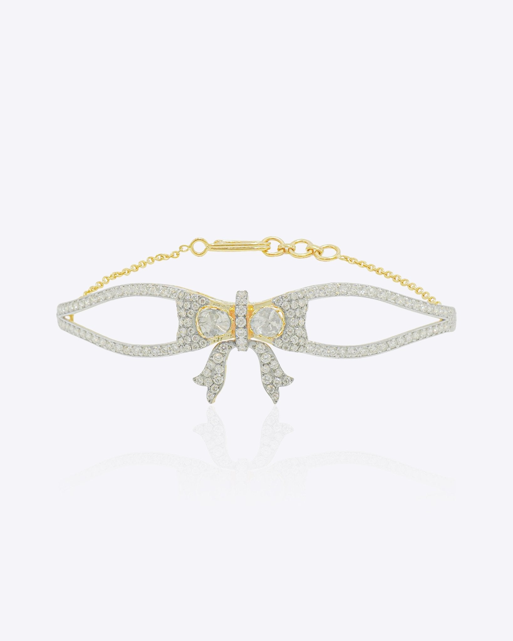 Silk Bow Bracelet in 14kt gold with a refined bow design and interlaced stones