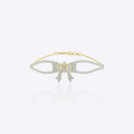 14K gold bracelet with an elegant bow design and vibrant interlaced stones creating a refined statement look.