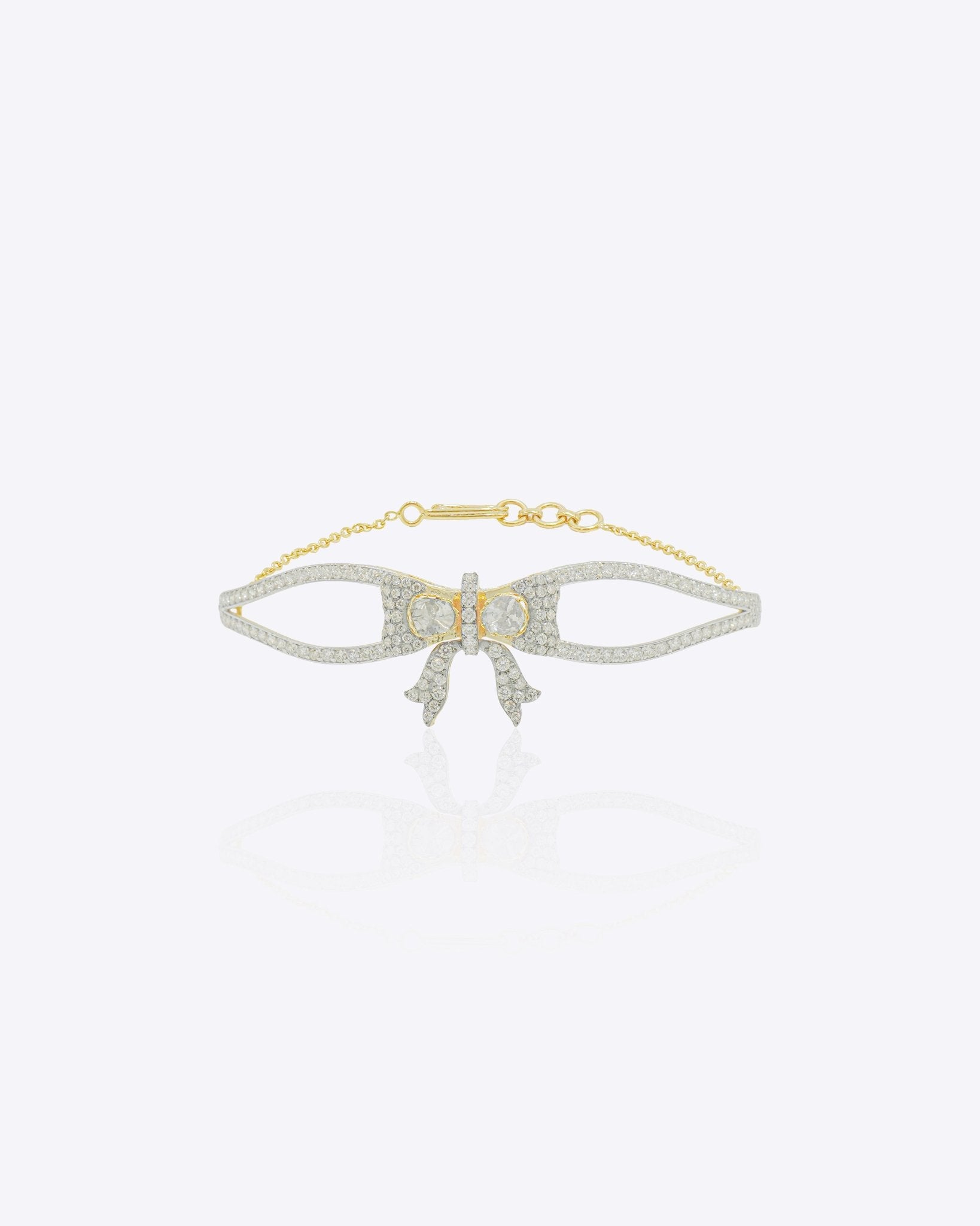 14K gold bracelet with an elegant bow design and vibrant interlaced stones creating a refined statement look.