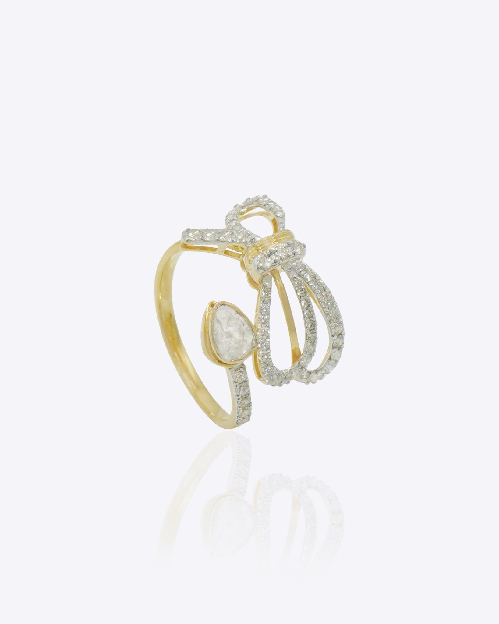 14k gold ring with a sleek, minimalist bow silhouette.