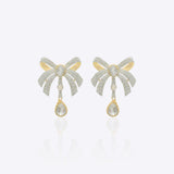 14K gold earrings with a 3D folded bow design and cascading stones.