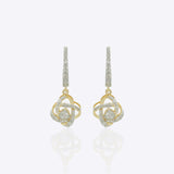 14K gold woven-texture knot earrings with a central luminous stone.