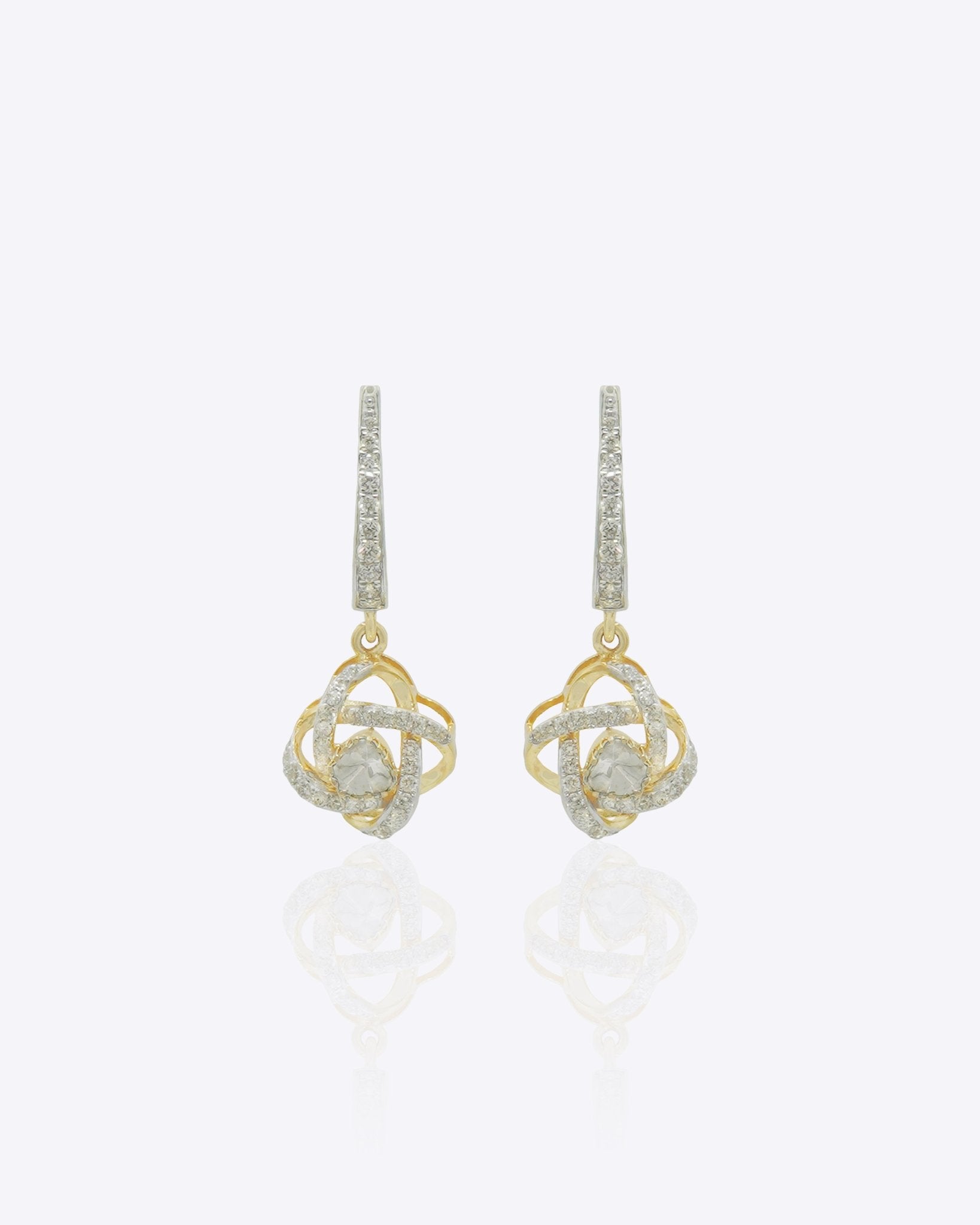 14K gold woven-texture knot earrings with a central luminous stone.