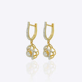 14K gold woven-texture knot earrings with a central luminous stone.