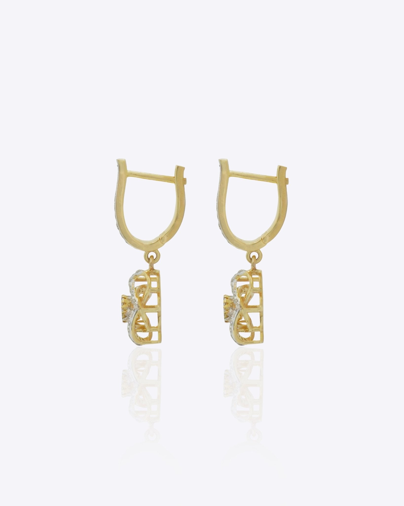 14K gold woven-texture knot earrings with a central luminous stone.