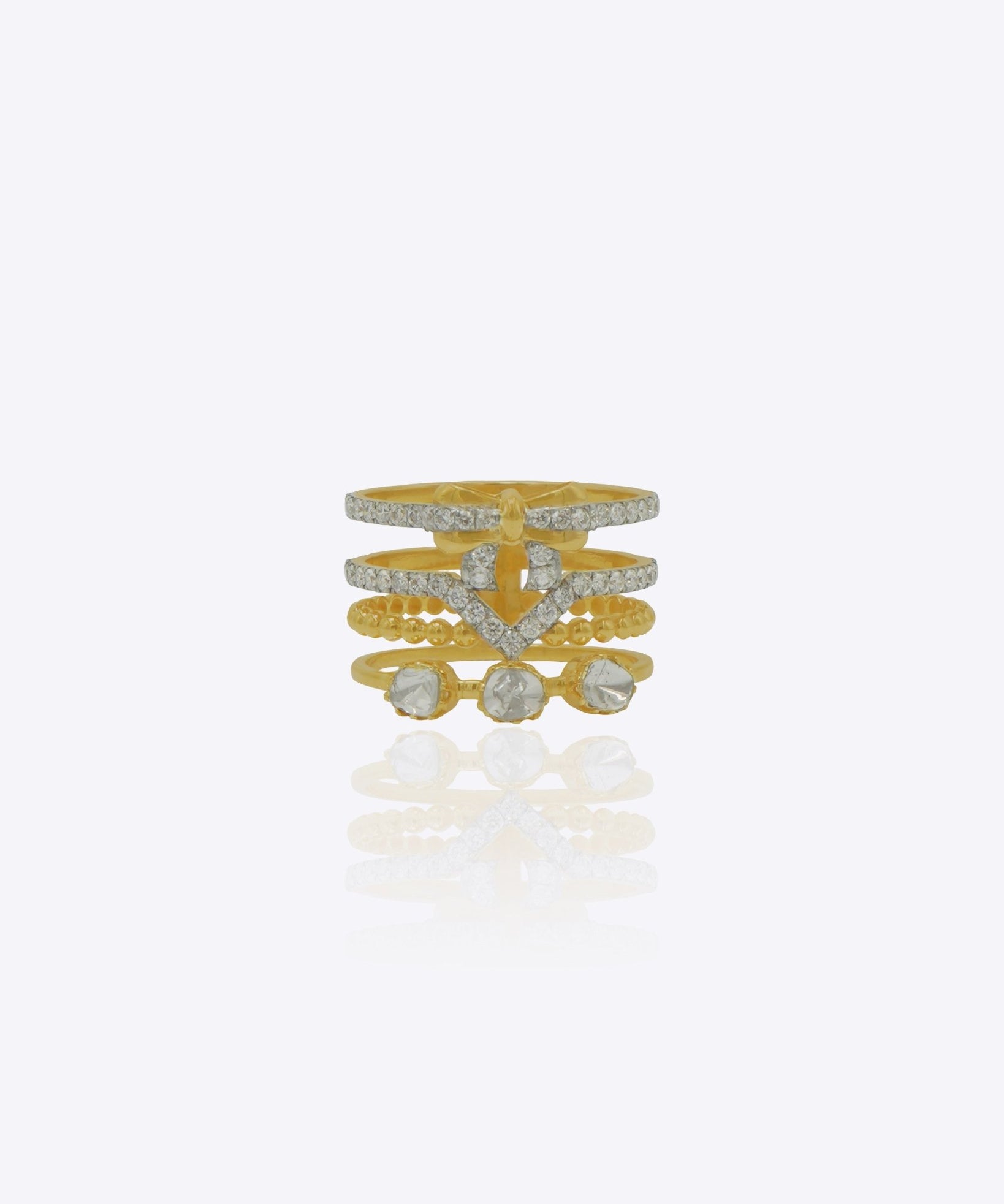 14K gold tiered ring with layered bands, bow motif, V-shaped accents, and three uncut stones.