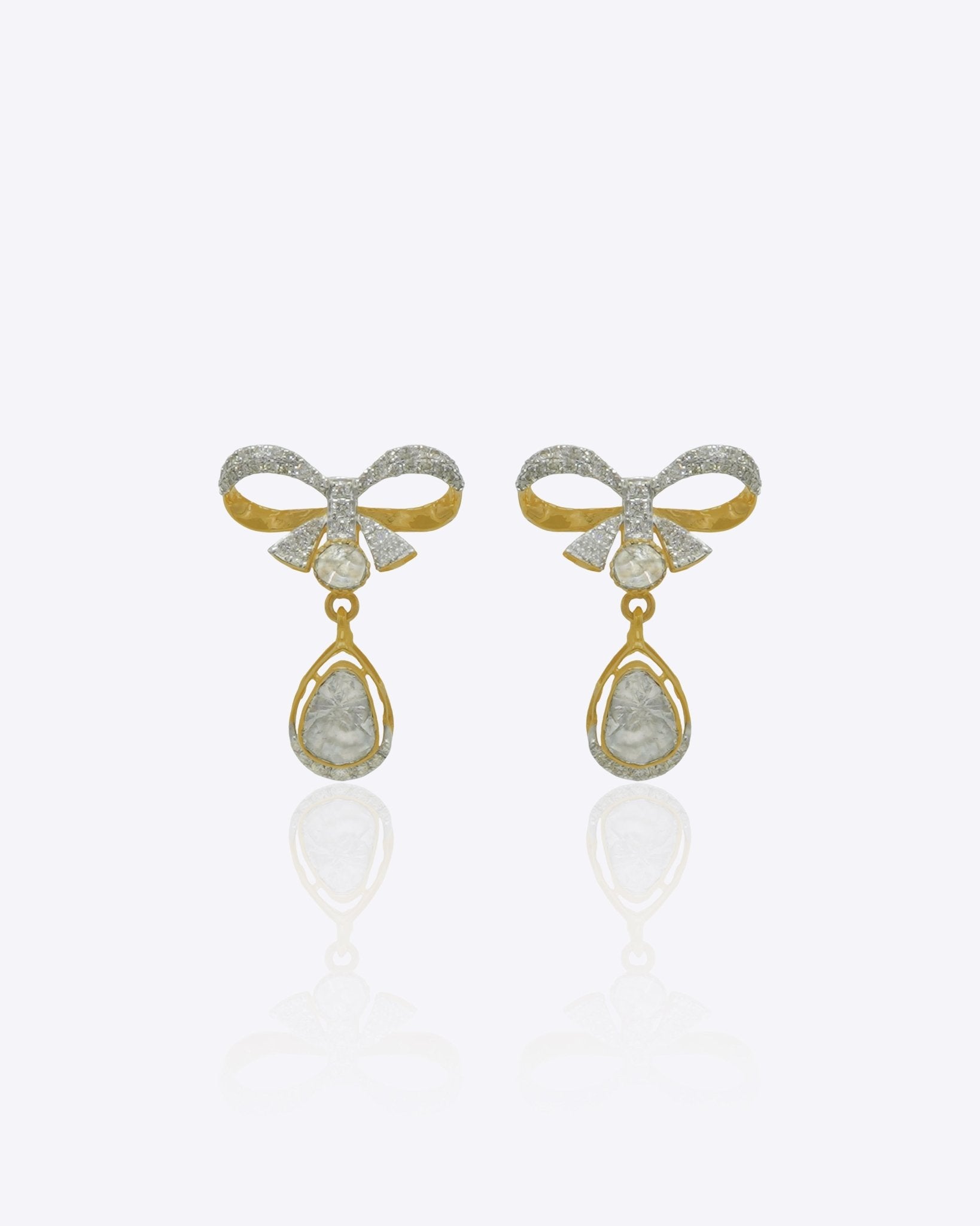 14kt gold earrings featuring a delicate bow motif with small stones and a hanging pear-shaped gemstone droplet.