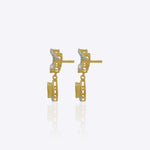 14K gold bow-motif drop earrings with a pear-shaped stone.