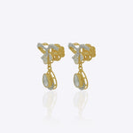 14K gold bow-motif drop earrings with a pear-shaped stone.