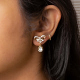 14K gold bow-motif drop earrings with a pear-shaped stone.