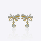 Elegant curved drop earrings with a delicate bow-inspired design and graceful cascading silhouette.