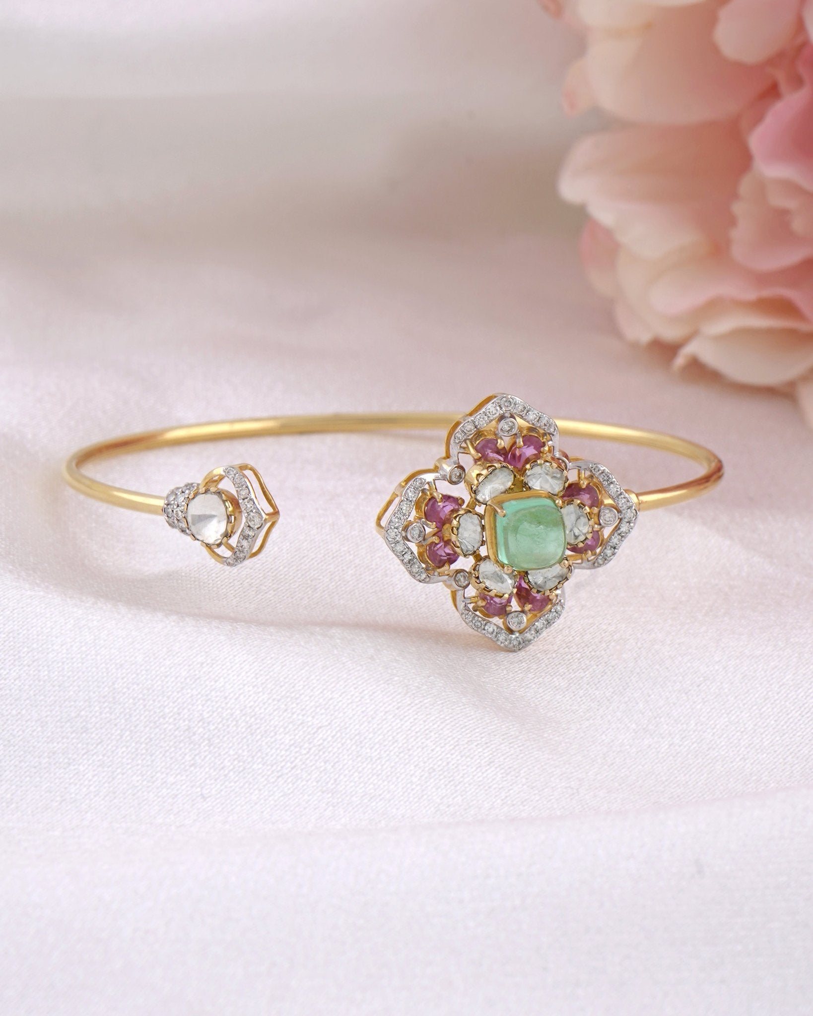 Rose Eclat Bangle in 14K gold with floral Polki motif and emerald-green centre stone
