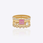 Featuring a multi-layered gold band with a pink center stone and Polki detailing.