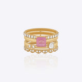 Featuring a multi-layered gold band with a pink center stone and Polki detailing.