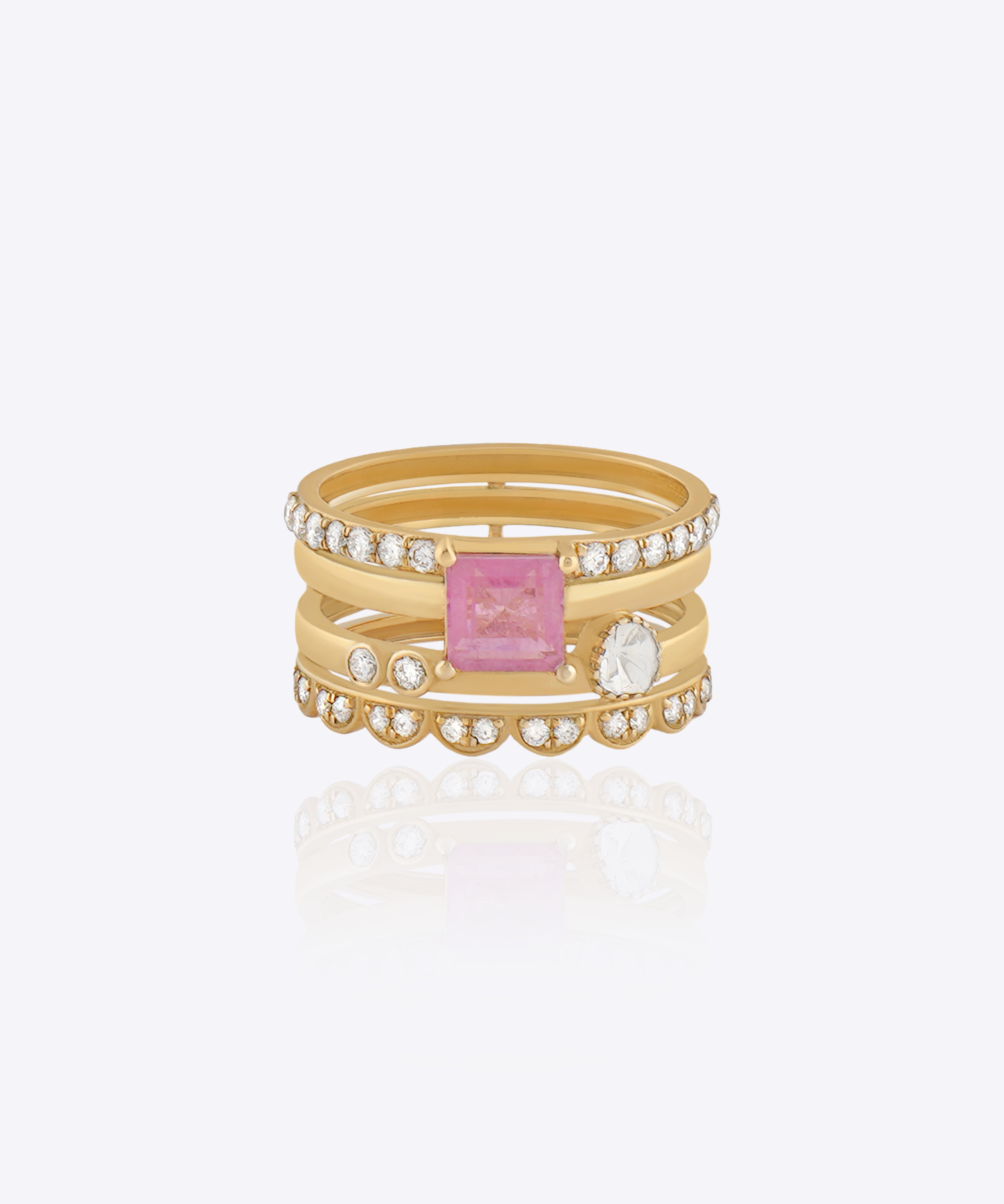 Featuring a multi-layered gold band with a pink center stone and Polki detailing.