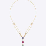 Featuring a layered gold chain with a gemstone cluster and teardrop-shaped green stone pendant.