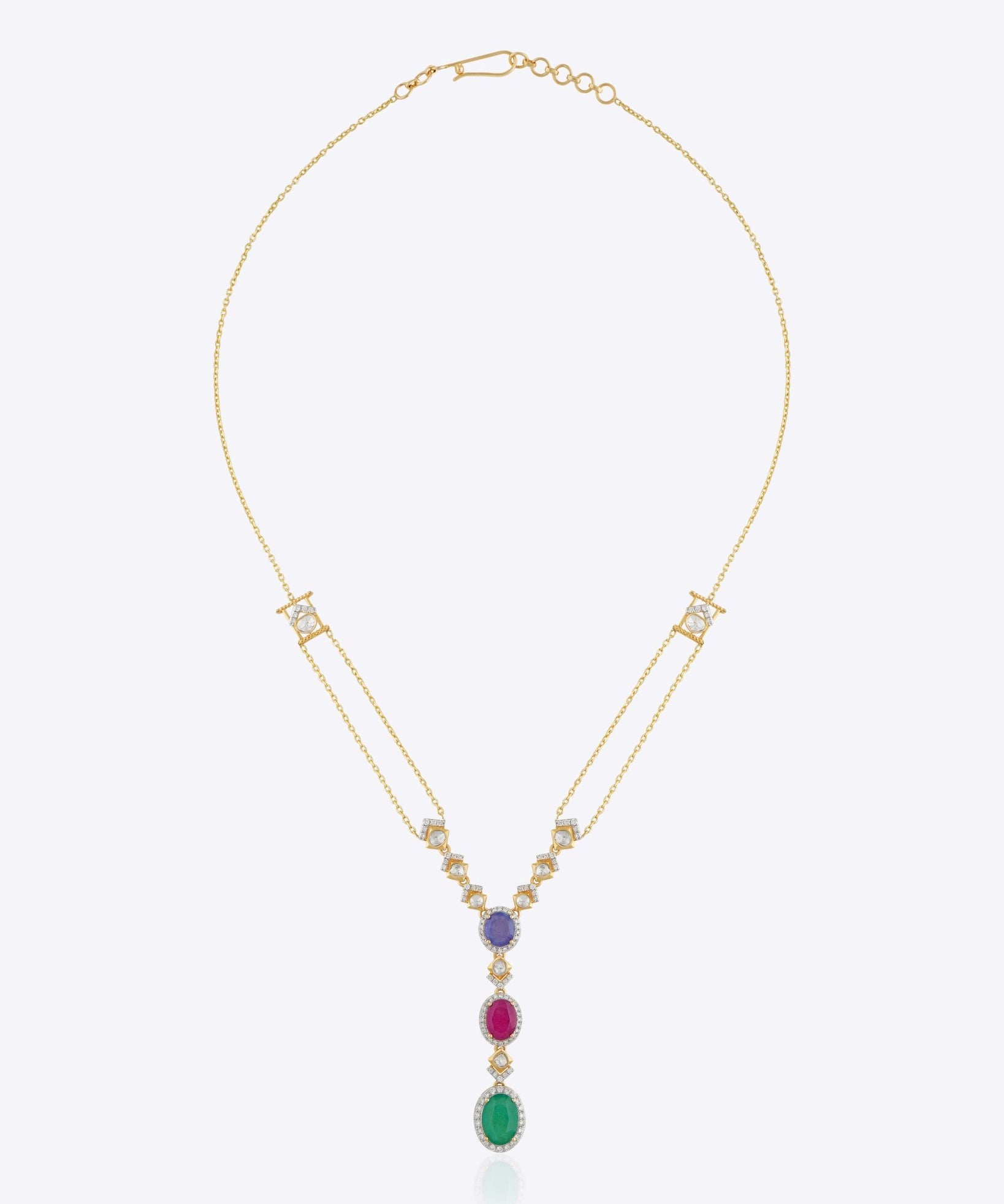 Featuring a layered gold chain with a gemstone cluster and teardrop-shaped green stone pendant.