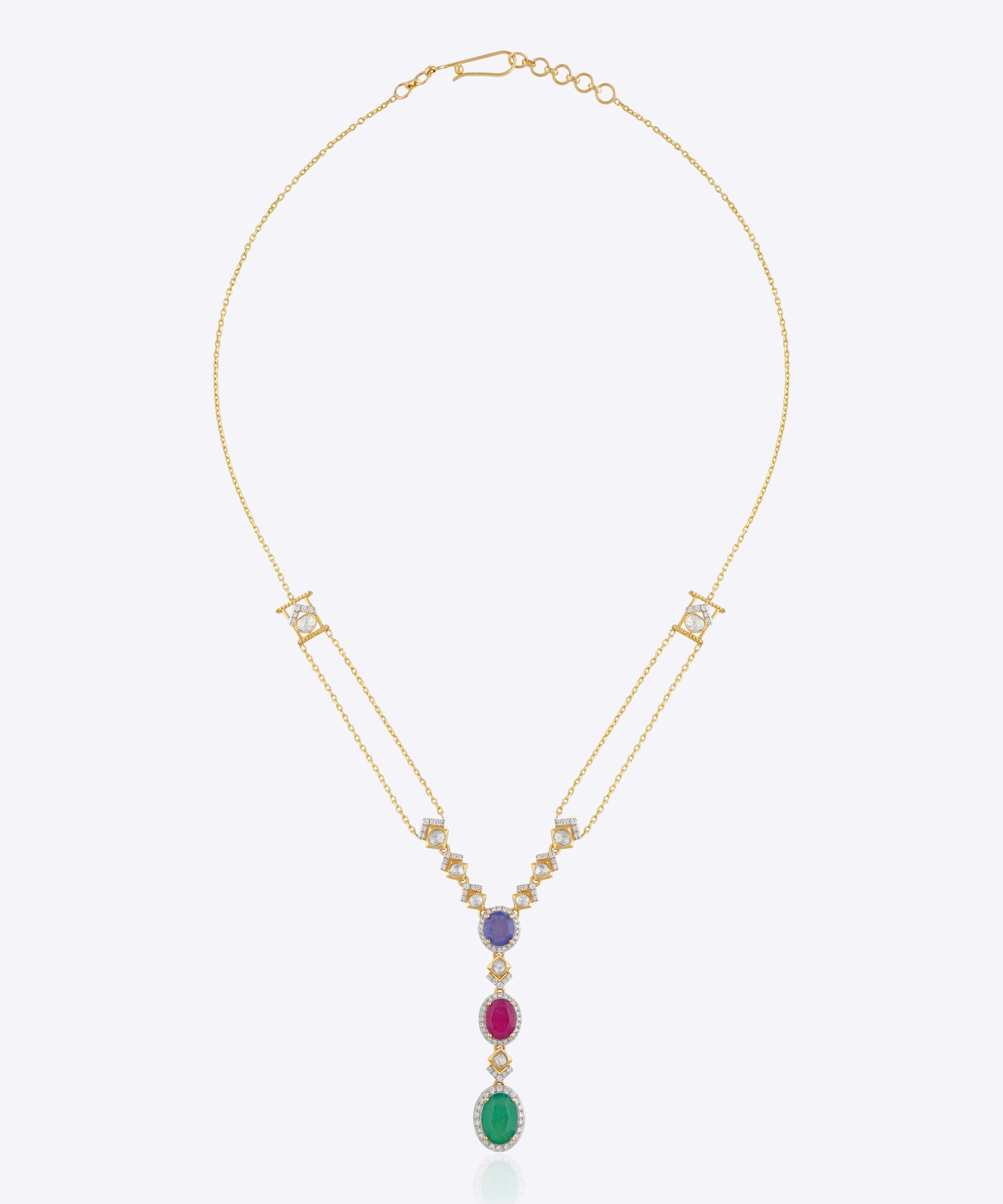 Featuring a layered gold chain with a gemstone cluster and teardrop-shaped green stone pendant.