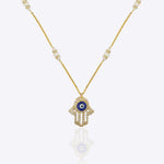 14k gold necklace with an Evil Eye and Hamsa symbol in diamonds