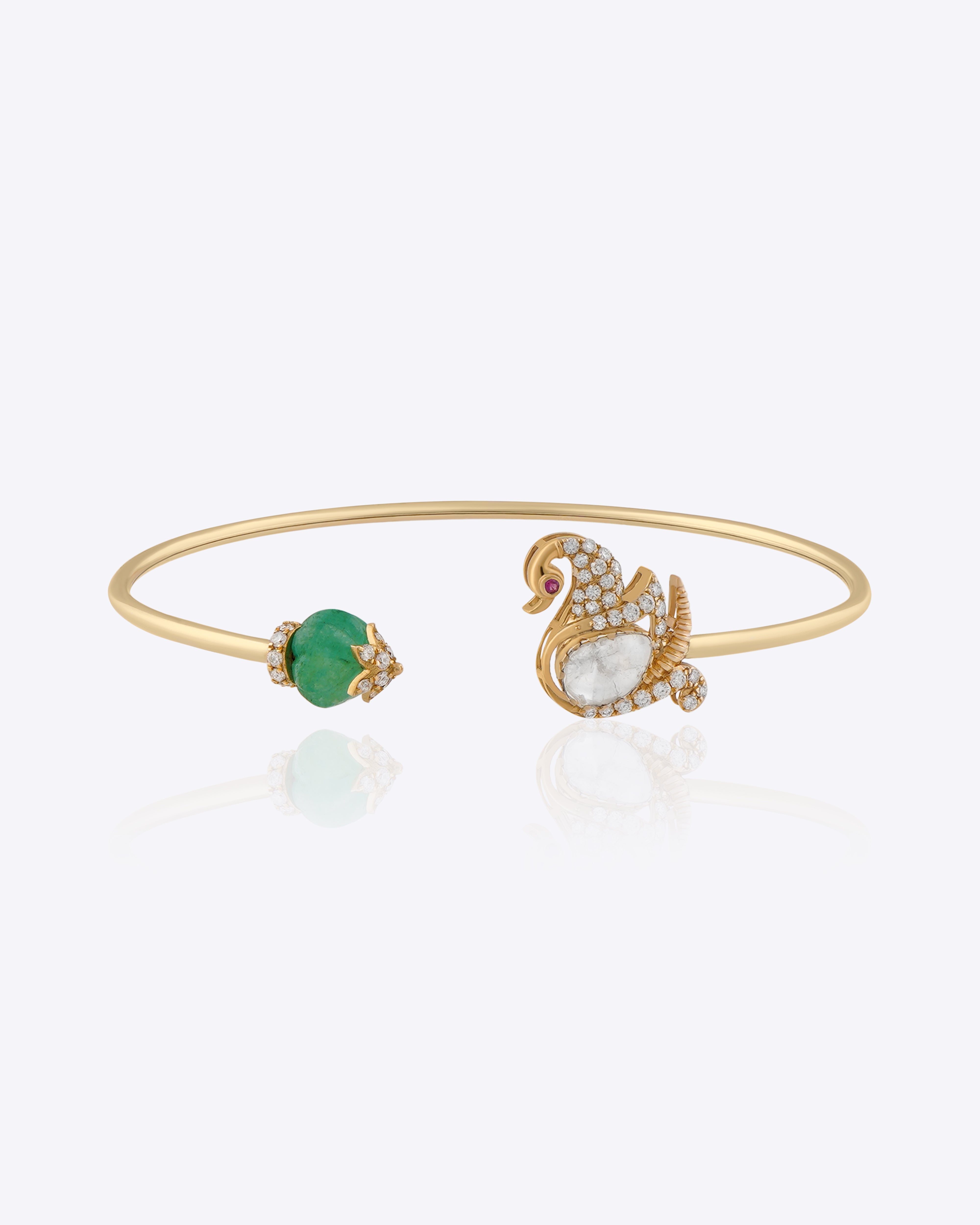 Swan Symphony gold open bangle with Polki swan motif, blue gemstone accent and elegant craftsmanship.