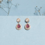 Oval ruby and Polki diamond drop earrings in 14K gold with a double-halo design.