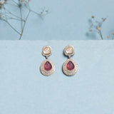 Oval ruby and Polki diamond drop earrings in 14K gold with a double-halo design.