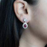 Oval ruby and Polki diamond drop earrings in 14K gold with a double-halo design.