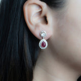 Oval ruby and Polki diamond drop earrings in 14K gold with a double-halo design.
