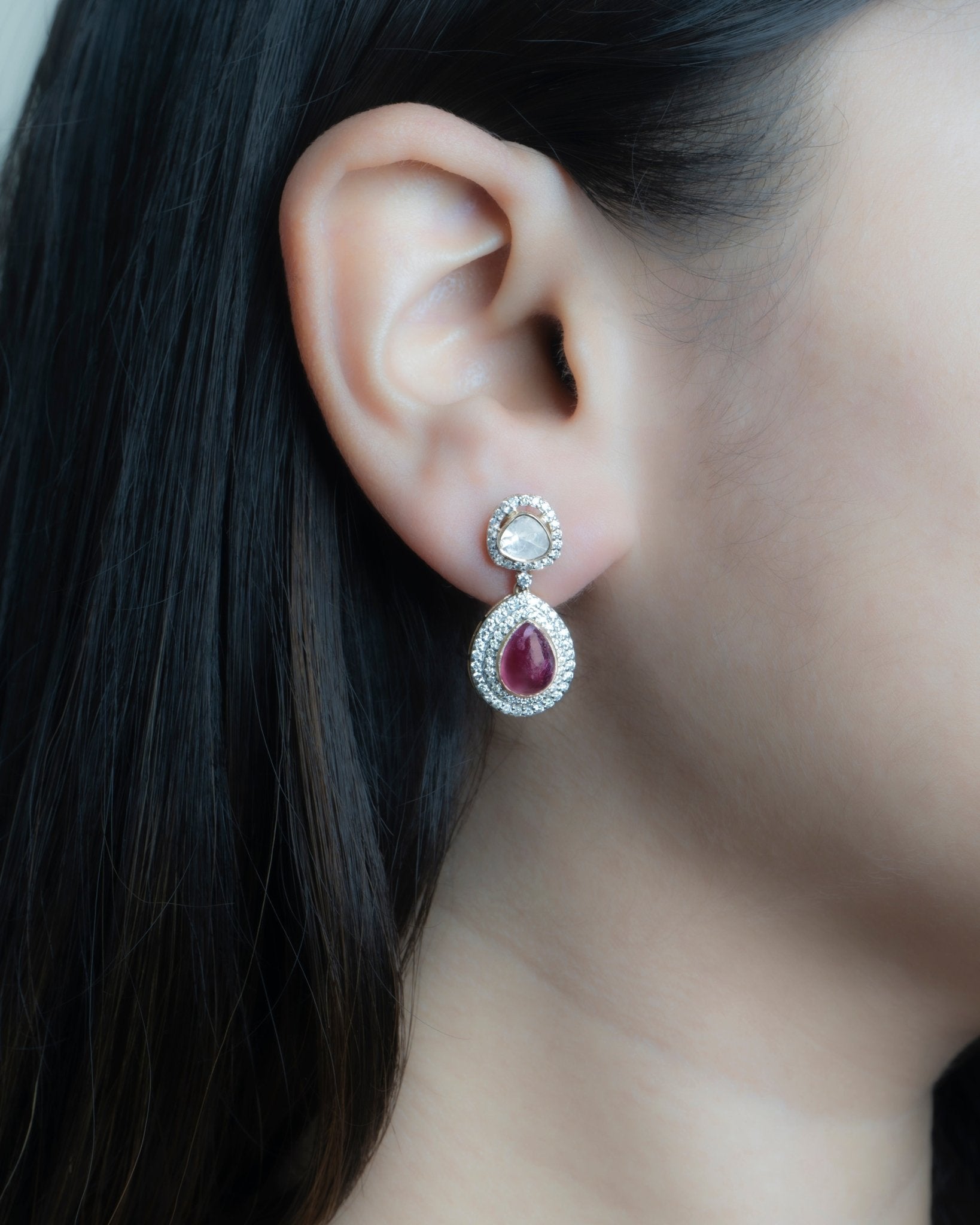 Oval ruby and Polki diamond drop earrings in 14K gold with a double-halo design.