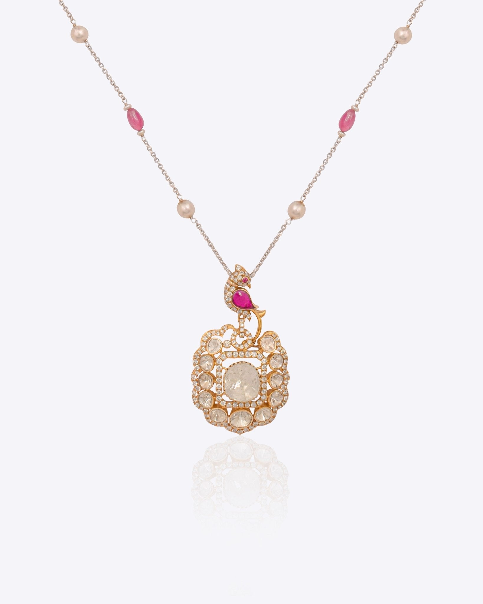 Rose-toned Polki pendant in 14K gold with soft pink stone drop, styled for evening wear.