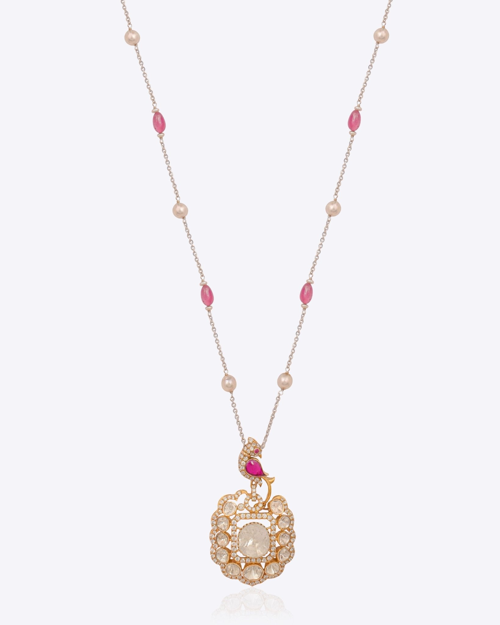 Rose-toned Polki pendant in 14K gold with soft pink stone drop, styled for evening wear.