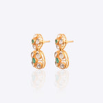 18K gold earrings with a central Polki diamond surrounded by vibrant emeralds.