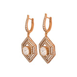 Hexagon-shaped earrings with 14k gold frames and Polki diamonds. A stylish mix of vintage and modern design.