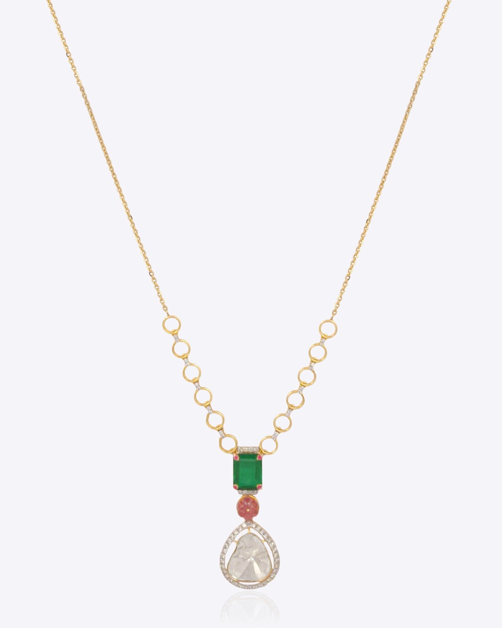 14K gold necklace with teardrop Polki, ruby, and green stone accents.