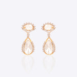 18k gold drop earrings with circular Polki diamonds in a gardenia-inspired frame.