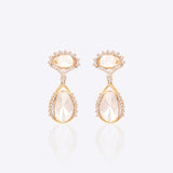 18k gold drop earrings with circular Polki diamonds in a gardenia-inspired frame.