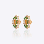 14K gold floral drop earrings set with Polki diamonds and emerald accents.