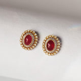 14k gold stud earrings with ruby center and uncut diamond halo