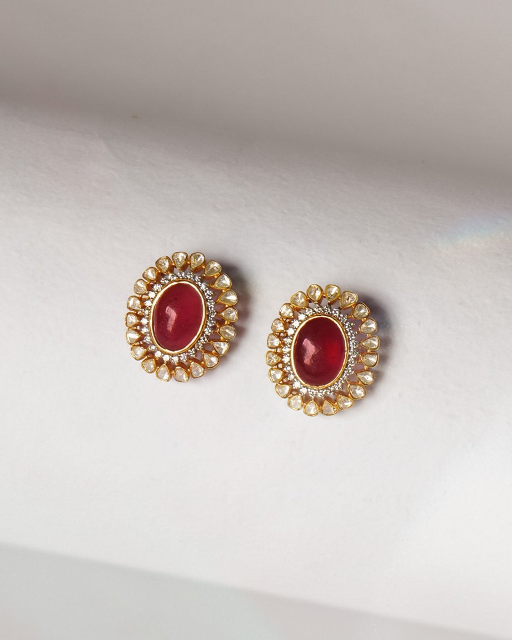 14k gold stud earrings with ruby center and uncut diamond halo