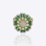 14k gold ring with a luminous Polki center and emerald accents.