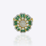 14k gold ring with a luminous Polki center and emerald accents.