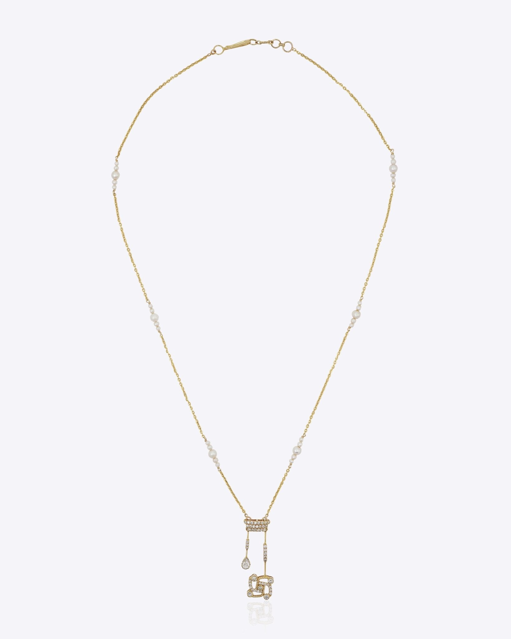 Swastik Sutra Necklace in 14K gold with pearls, Polki, and diamonds around a sacred Swastik.