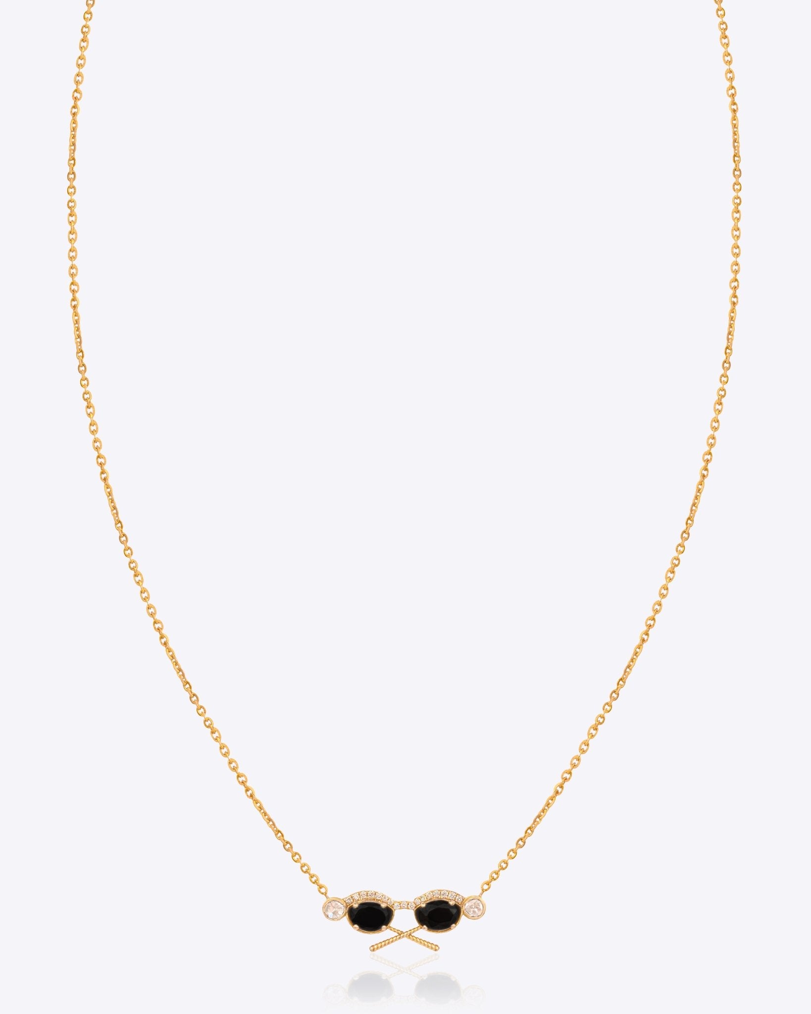 14k gold pendant with black and uncut diamonds in a delicate design.