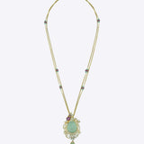 14K gold necklace with a luminous emerald surrounded by Polki diamonds.