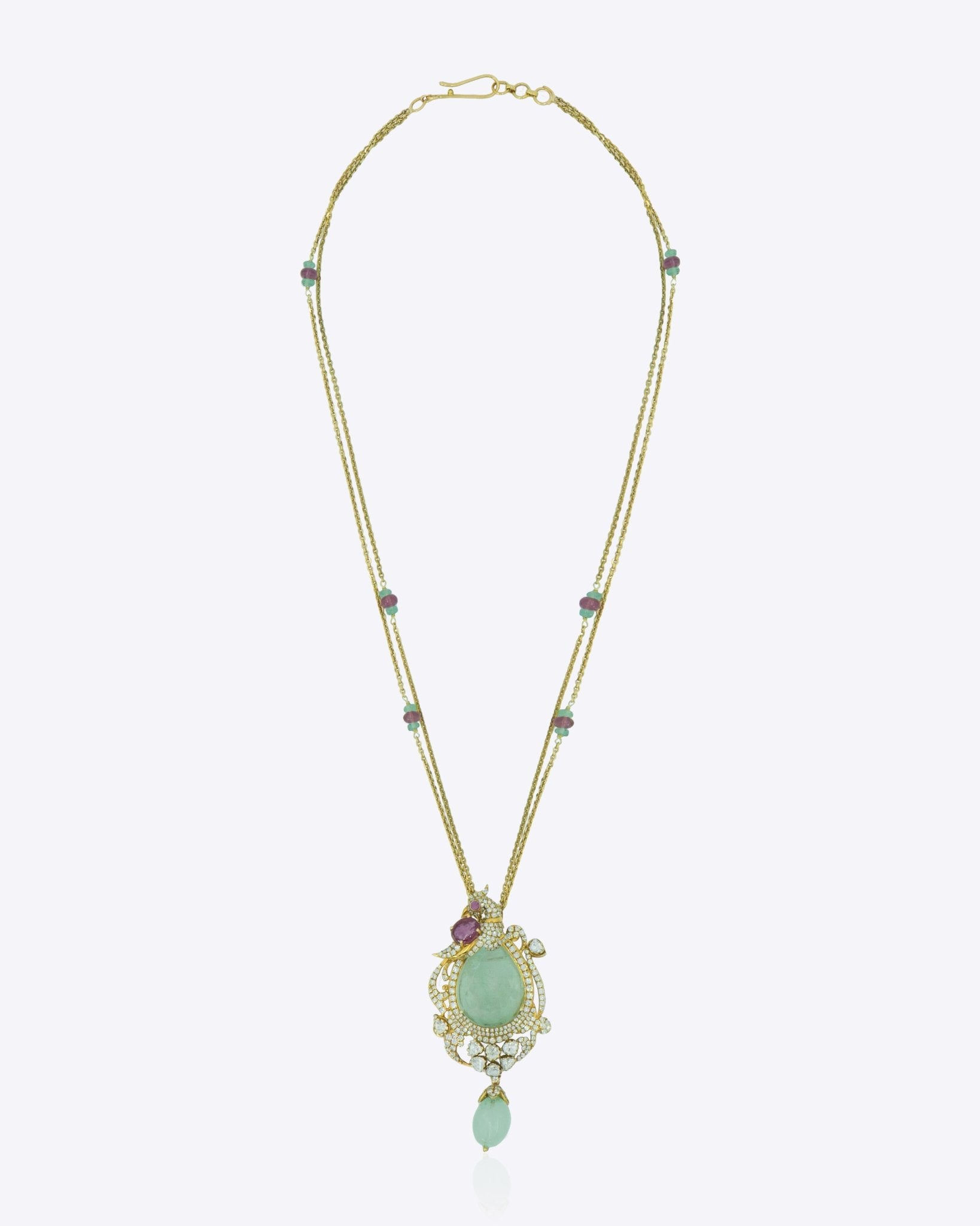 14K gold necklace with a luminous emerald surrounded by Polki diamonds.