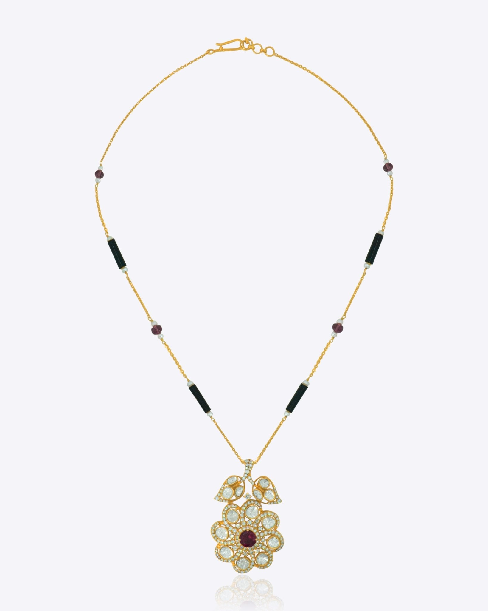 14K gold Obsidian Petal necklace with Polki, diamonds, and black onyx in a floral design.