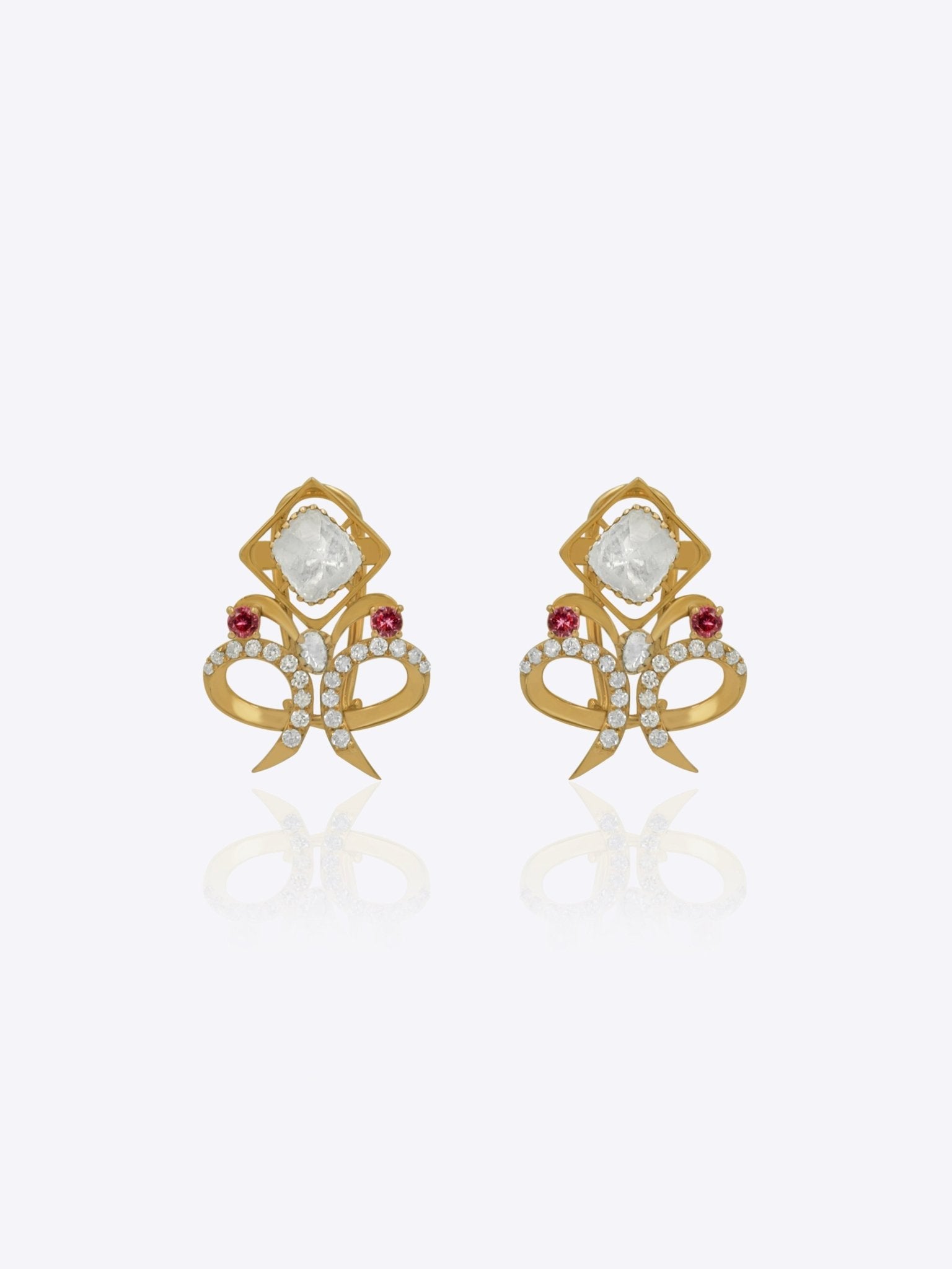 14K gold earrings with a cushion-cut Polki diamond in a diamond-shaped frame.