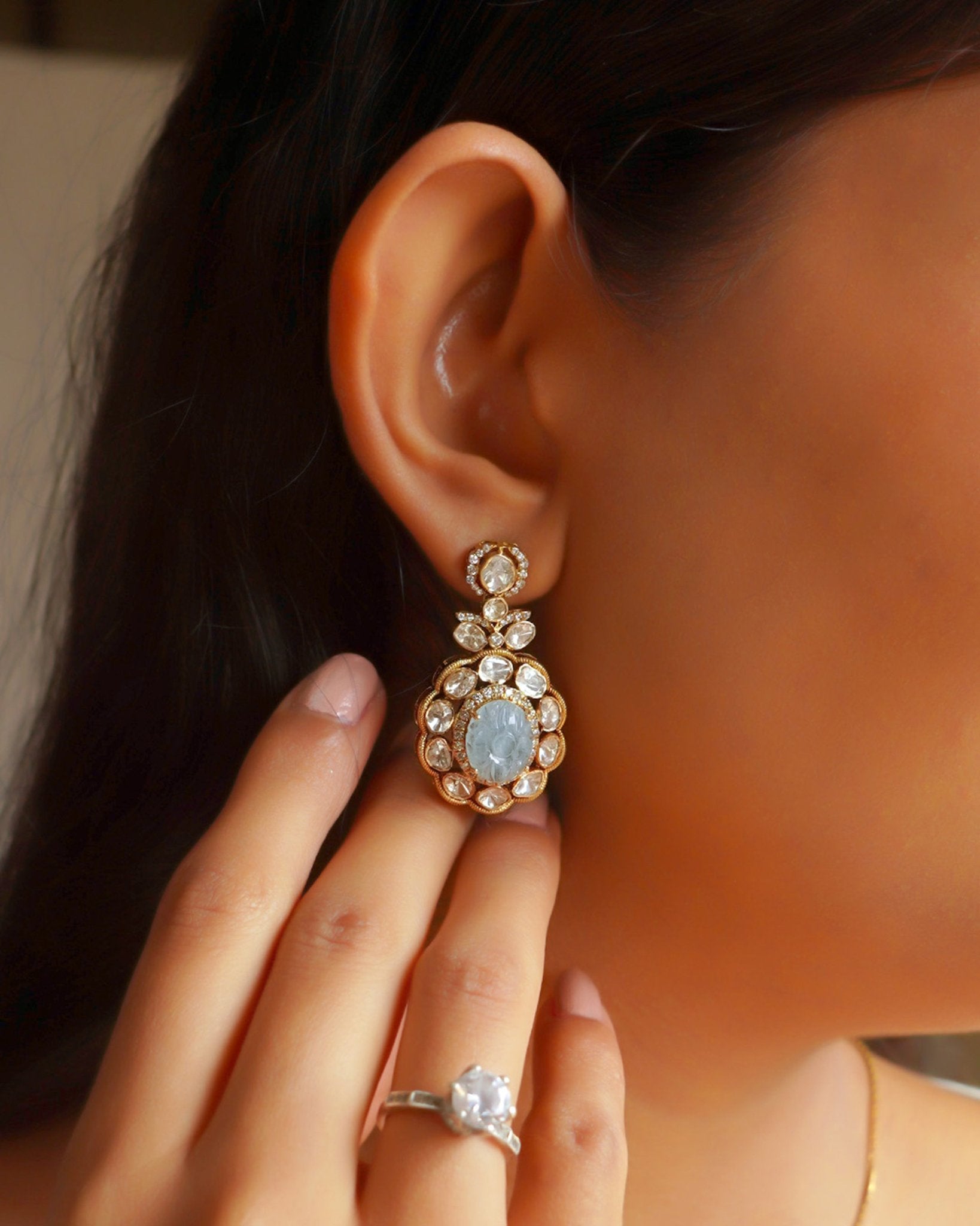 14K gold drop earrings with carved aquamarine centers and Polki diamond accents.