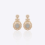 Antique gold Polki earrings photographed flat with emerald drops for wedding wear.